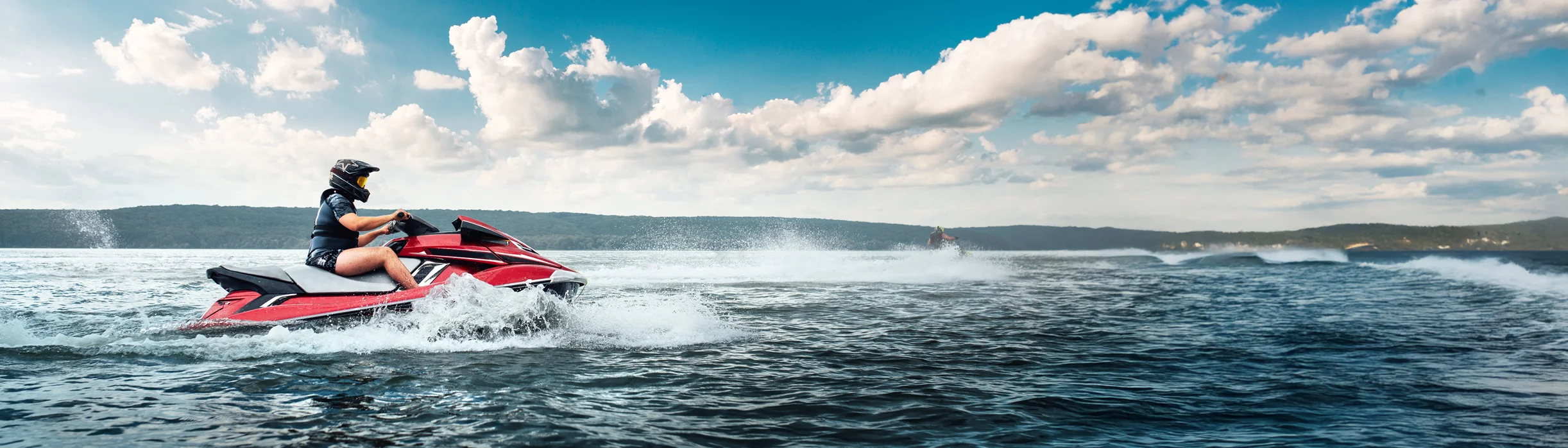 Person riding jetski across the ocean