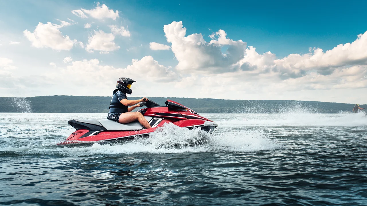Person riding jetski across the ocean