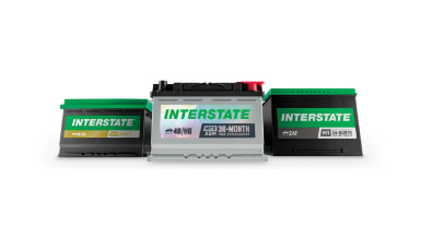 Three Interstate automotive batteries displayed together